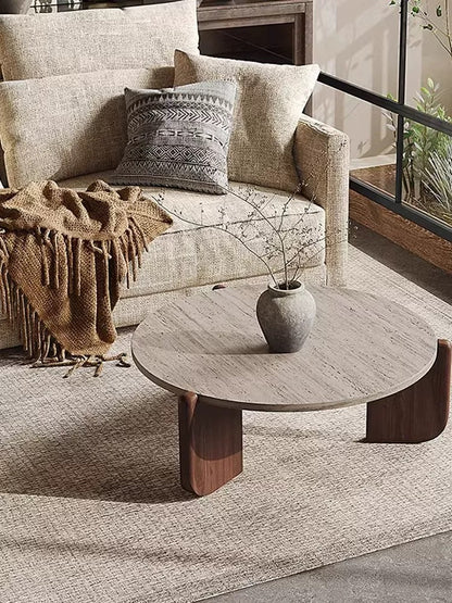 Angled shot of a low-profile coffee table showing the thick textured top and fin-style legs.