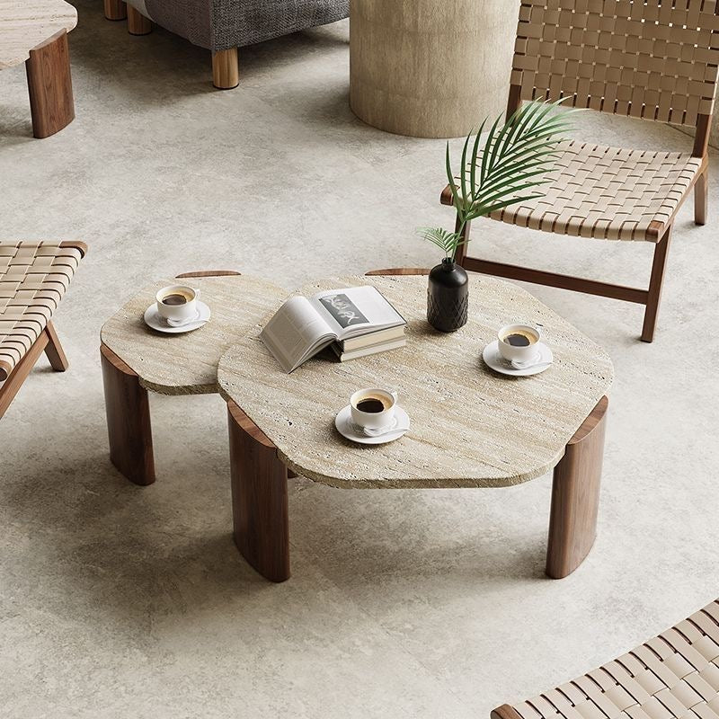 Travertine stone coffee table with walnut legs and organic cloud shape top.